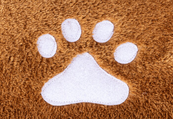Fototapeta na wymiar Brown wool rug texture with white cat footprint