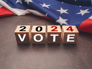 United States presidential election in 2024. Wooden cubes with text VOTE and 2024 over the American...