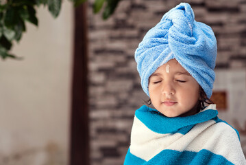 22 months old cute  Indian baby girl wearing blue Hair Towel Wrap Turban and body wrapped with blue...