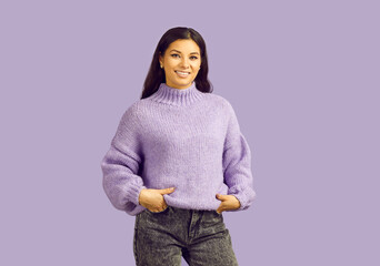 Portrait of smiling Latino woman in casual clothes isolated on purple studio background. Happy...