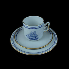 Antique British blue porcelain tea set with ship motifs.antique cup and saucer with a picture of a ship service close-up