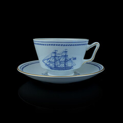 Antique British blue porcelain tea set with ship motifs.antique cup and saucer with a picture of a ship service close-up
