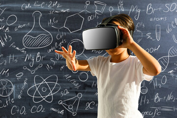 Girl with virtual reality glasses in classroom. Concept of school and modern technology