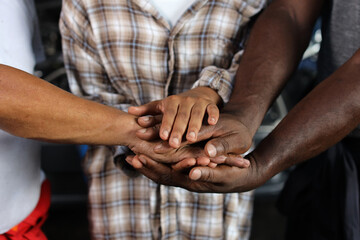 Group of man and woman technician engineer or worker standing and stacking hands celebrate successful together or completed deal commitment at heavy industry manufacturing factory