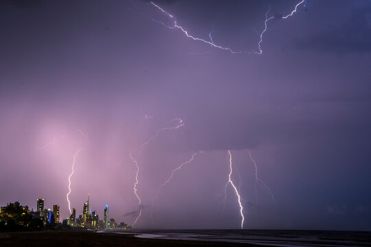 Lightning bolts across the night sky against the Gold Coast cityscape