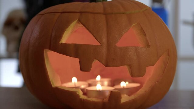 Halloween concept. Pumpkin glows on Halloween. Traditional Halloween symbol. Halloween pumpkin smile and scary eyes for party.
