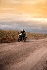 Photo of a motorcyclist at sunset.