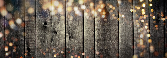 Christmas background - Old wooden board with golden bokeh lights and copy space - banner, panorama - rustic xmas decoration