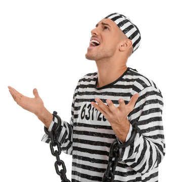 Emotional prisoner in striped uniform with chained hands on white background