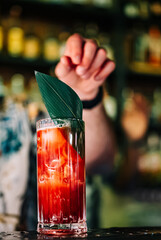 bartender making cocktail in a nightclub bar
