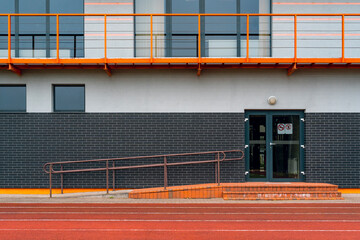 Building entrance with ramp for disabled person wheelchair