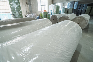 Large rolls of paper in a paper recycling factory.