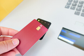 the hand of an unrecognizable person swiping a credit card on the wireless