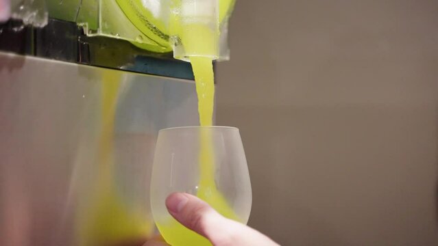 Close Up Of Green Frozen Slushie Being Served From Machine Into Glass, 4K Slow Motion