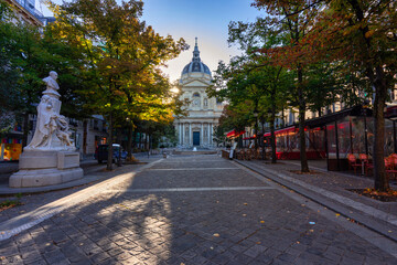 Facade of the Sorbonne University building surrounded by trees in the colors of autumn, Paris....
