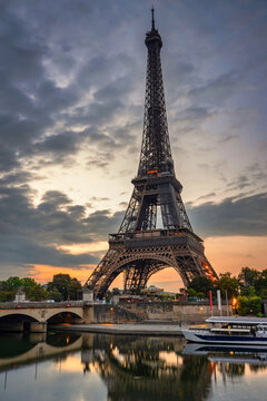 Eiffel Tower by the Seine River in Paris at sunrise. France