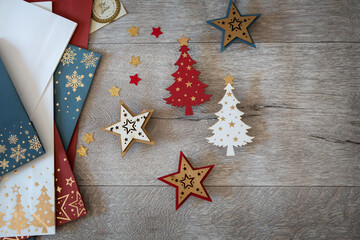 Wooden decorative objects - wooden Christmas trees and wooden stars for decorating New Year and Christmas gifts lie on a wooden background.