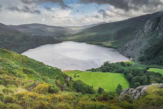 Dramatic sky over Lough Tay called The Guinness Lake in deep valley surrounded by Wicklow Mountains, Ireland