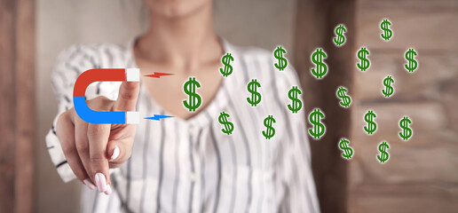 Human hand showing Magnet and dollar symbols. Money attracting