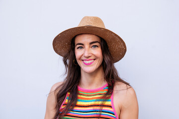 Smiling woman in hat and colorful t-shirt.