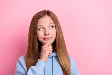 Closeup photo of young funny curious cute little lady long hair dreamy touch chin look interested empty space offer isolated on pink color background