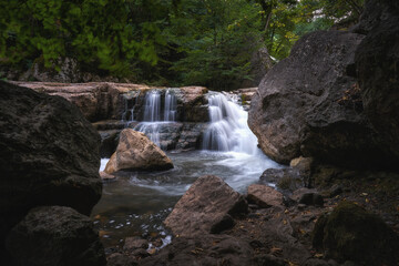 Fototapeta na wymiar Small waterfall at Sarnajur river in the woods
