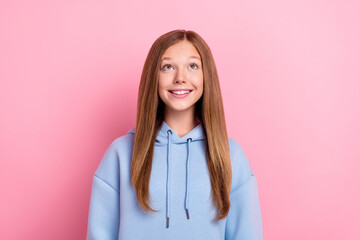 Photo of young pretty cute toothy smile school child girl brown long hair positive excited look empty space up new information isolated on pink color background