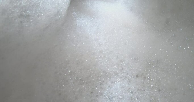 4K video slow motion Moving Bubble soap in bath tube. Background for bathroom and spa relaxing.