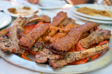 Traditional Turkish Adana kebab or kebab meat dishes, appetizers, on the table in Turkish restaurant, top view.