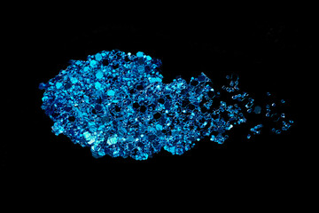 Blue glitter makeup product smear on black. Eye shadow, lip gloss and face for holiday makeup swatch