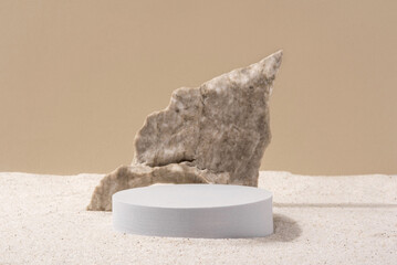 Background for cosmetic products of natural beige color. Stone podium on the sand. Front view.