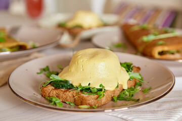 Vegan dish with wholegrain bread, smoked tofu, parsley, greens, pea sprouts, herbs close up.