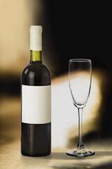 Bottle of tasty red wine with a glass on desk