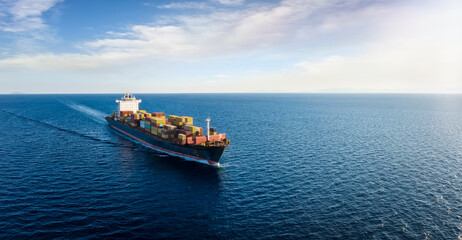 Panoramic aerial view of a cargo ship carrying containers for import and export, business logistic and transportation in open sea with copy space 