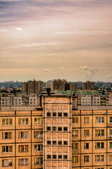 Fototapeta premium Big pink clouds in the sky over high buildings in the Obolon district of Kiev, Ukraine, near the Minska metro station.