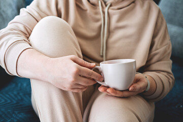 Self care, staying home, cozy mood. Take care of yourself, Love yourself concept. Woman hands with cup of hot drink at home