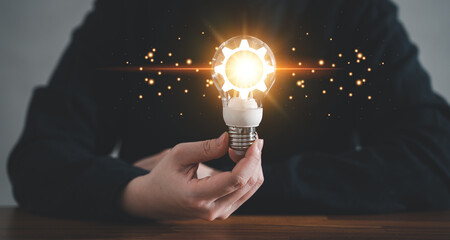 Innovation design concept. Hand holding light bulb for new idea brain storming creative inspiration.