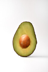 Half avocado detail on white background