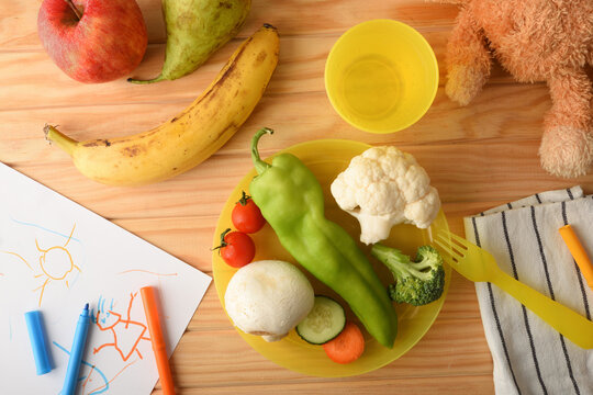 Concept of fun fruit and vegetables served for child top