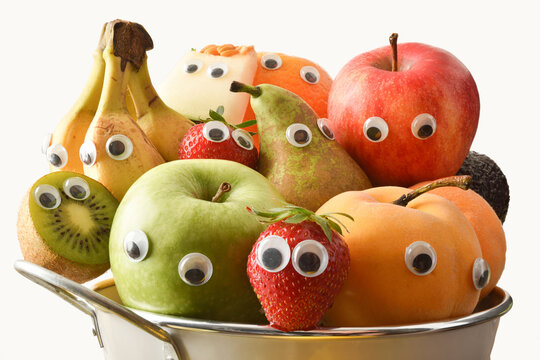 Fruit bowl full of fruit with eyes white isolated