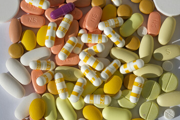 Lots of colorful medicines and pills from above. Pills in yellow colors
