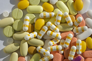 Lots of colorful medicines and pills from above. Pills in yellow colors