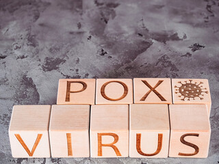 Pandemic or spread of disease concept as VIRUS POX inscription on wooden cubes