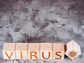 Pandemic or epidemic as a concept of disease spread as VIRUS text on wooden cubes