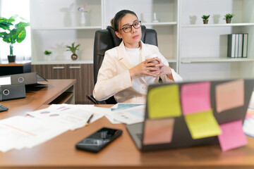 beautiful business asian woman thinking. calm asian employee thinking while having a meeting with online group team using laptop. a female office worker using brain imagine business work plan party