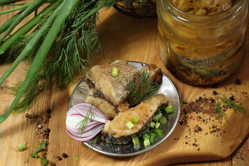 Pike canned in a glass jar on a wooden table