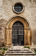 Fototapeta na wymiar Old church door in the old town of Savoca, Sicily, Italy.
