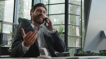 Caucasian cheerful bearded man boss manager salesman worker agent investor lawyer 40s businessman sitting in office talking phone friendly conversation smartphone discuss corporate company project