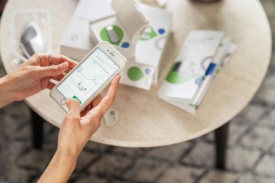 MINSK, BELARUS - AUGUST, 2022: Woman is preparing monitoring of blood sugar level Dexcom One. Life with diabetes