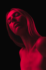 Desire and love. Dark red night. Young sensual woman in neon light on dark background. Cyberpunk...